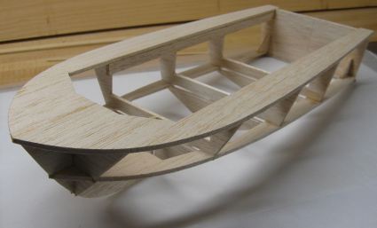 The RC boat hull flipped over ready for sanding and planking.