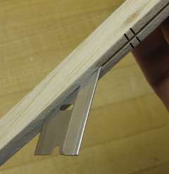 separating two duplicate balsa parts with a razor blade